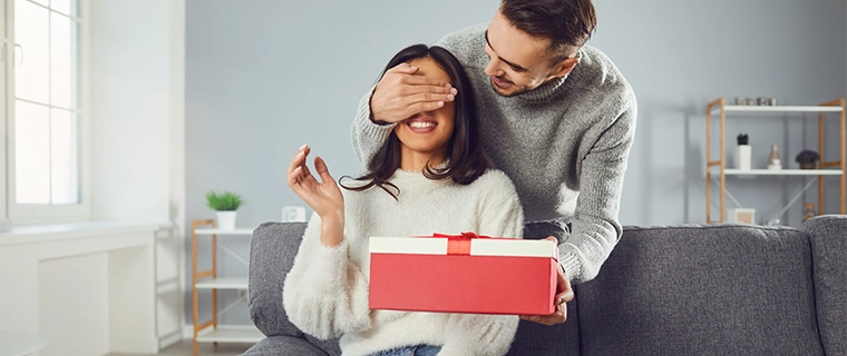 Man surprising woman with valentines gift