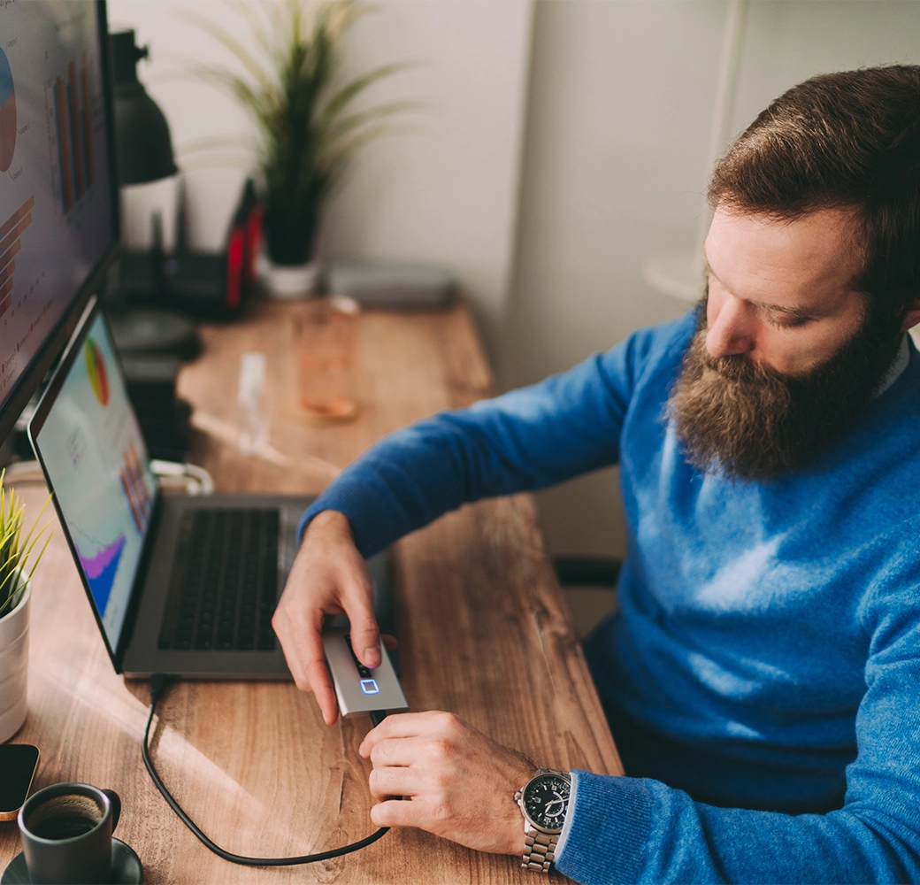 Man backing up computer data on hard drive