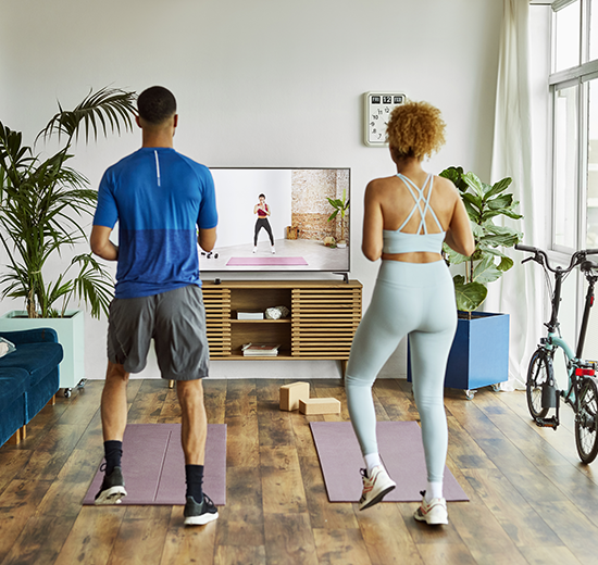 Couple doing exercise class at home