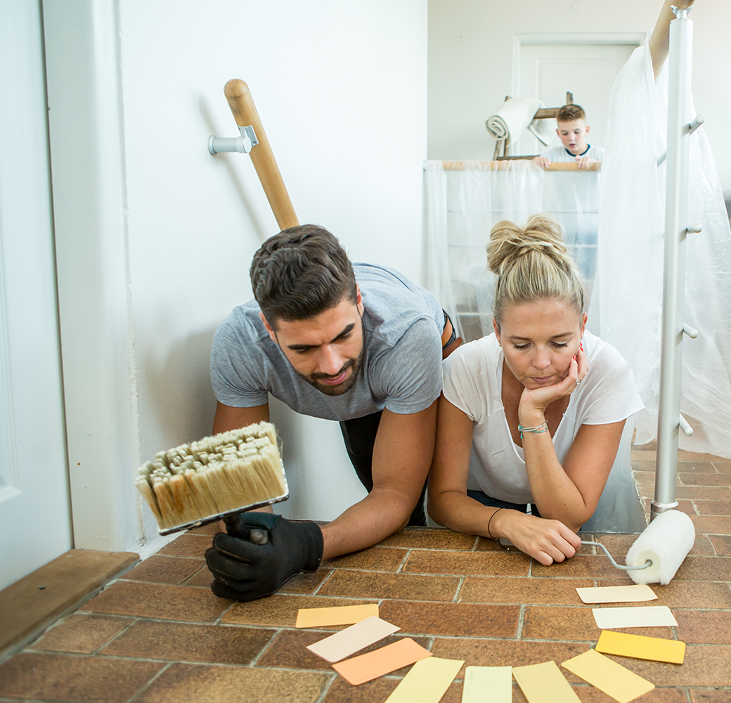 Couple laying on floor choosing paint colors
